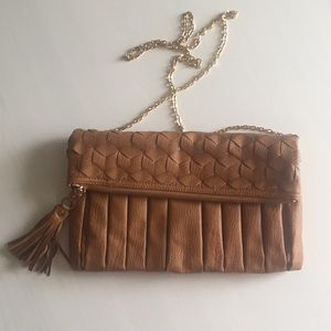 Clutch with removable crossbody chain strap.